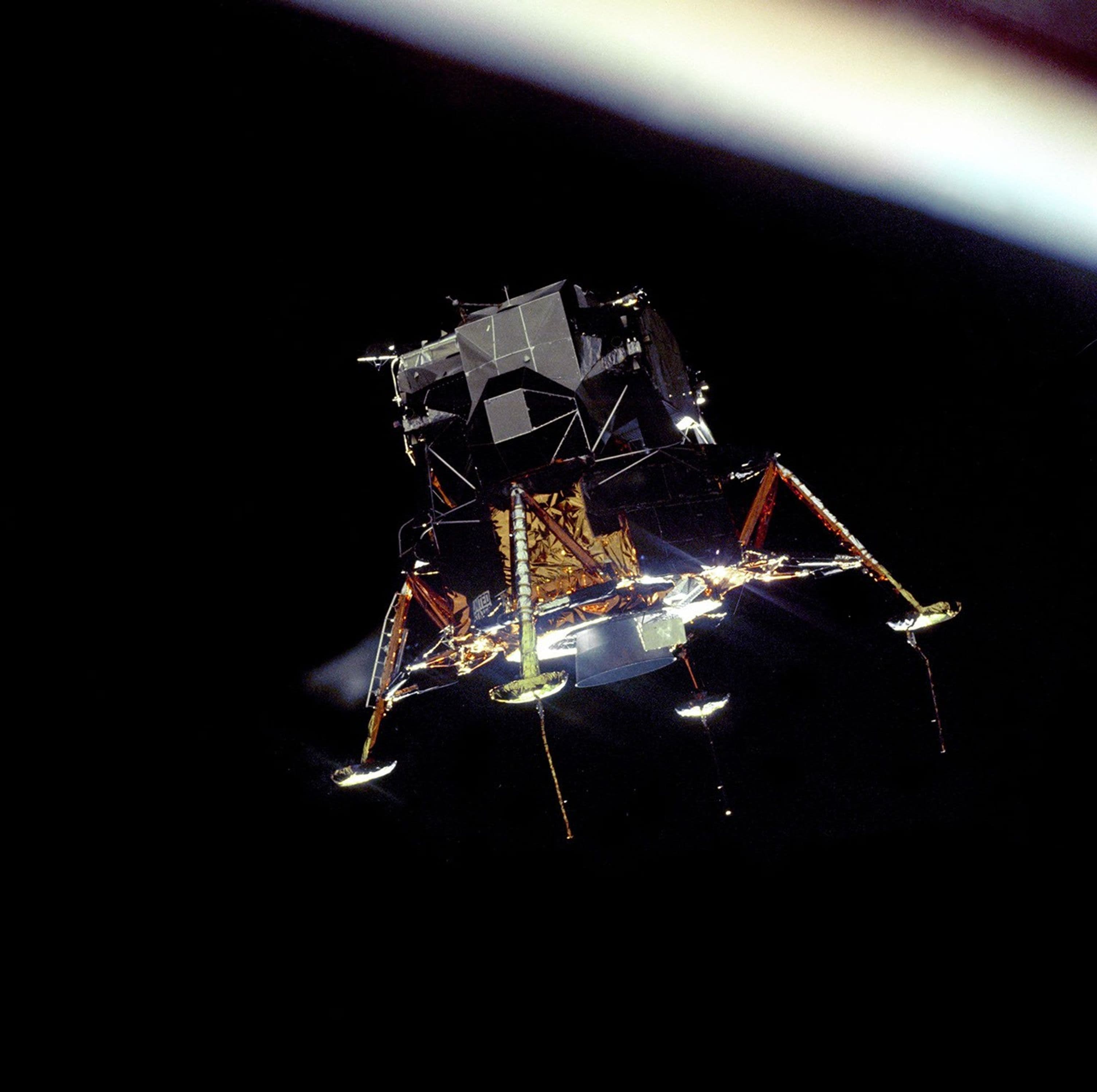 Apollo 11 lunar module Eagle in landing configuration above the Moon.